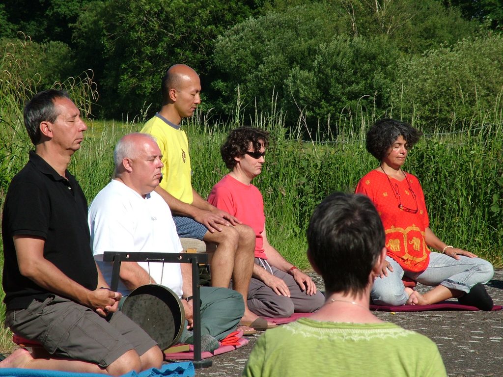 People meditating outside