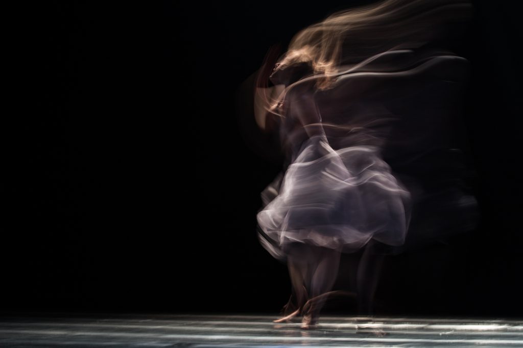 blurred dancer in white